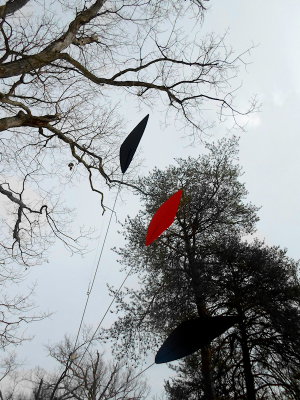 Photo of tall mobiles with trees and sky